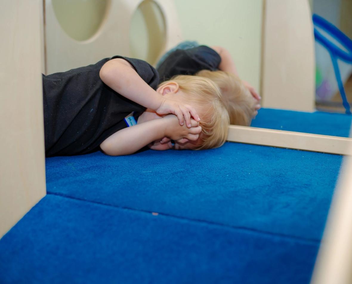 Toddler sensory play near a classroom mirror