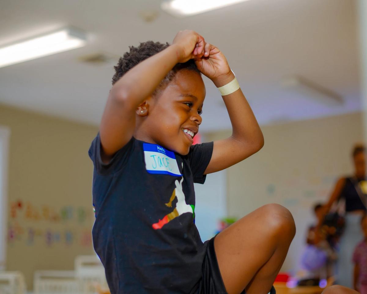 A joyful child engaged in classroom activity
